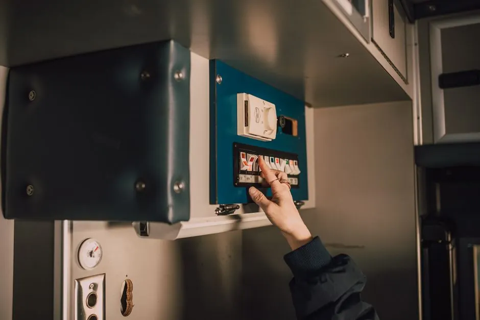 Close-up of a hand operating switches inside an ambulance. Perfect for healthcare and emergency themes.