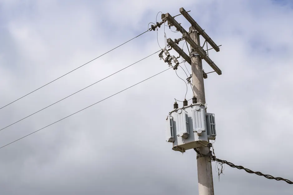 Low-angle shot of a power line on an electric post against a cloudy sky in São Paulo, Brazil.